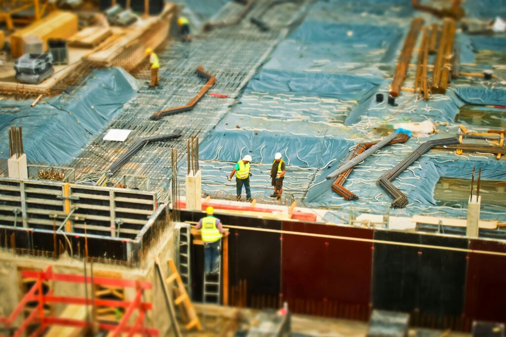 High-angle view of construction workers on a building site, engaging in construction work.